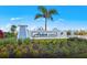 Arbor Oaks community sign surrounded by landscaping and a water feature at 1845 Ridgemore St, North Port, FL 34289
