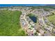Panoramic aerial shot showcasing the residential community with ponds, tree coverage, and coastal views at 2321 Wood Pointe Dr, Holiday, FL 34691