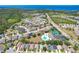 A picturesque aerial view of a community with a pool, tennis courts and beautiful homes at 2321 Wood Pointe Dr, Holiday, FL 34691