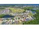 Aerial view of a neighborhood with a nearby baseball field and lake, creating a community-centric and nature-filled atmosphere at 2321 Wood Pointe Dr, Holiday, FL 34691