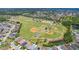 An aerial view of a well-maintained baseball field and adjacent residential area, perfect for sports enthusiasts and families alike at 2321 Wood Pointe Dr, Holiday, FL 34691