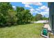 Spacious backyard with lush green grass and privacy fence, bordering a natural wooded area at 2321 Wood Pointe Dr, Holiday, FL 34691