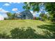 Expansive backyard with green lawn, screened enclosure and space for outdoor entertainment at 2321 Wood Pointe Dr, Holiday, FL 34691