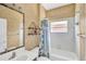 Cozy bathroom featuring decorative shower curtain and wall paper, framed mirror, and floating shelves at 2321 Wood Pointe Dr, Holiday, FL 34691
