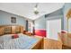 Bedroom with hardwood floors, ceiling fan, window with blinds, and red and gray walls at 2321 Wood Pointe Dr, Holiday, FL 34691
