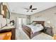 Main bedroom with ceiling fan, patio access, hardwood floors, and two bedside tables at 2321 Wood Pointe Dr, Holiday, FL 34691