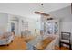 Dining room boasts decorative wainscoting, contemporary light fixtures, and wood floors at 2321 Wood Pointe Dr, Holiday, FL 34691