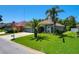 Charming single Gathering home featuring a three car garage, lush lawn and mature landscaping at 2321 Wood Pointe Dr, Holiday, FL 34691