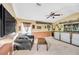 Game room with custom bar, large screen tv, and comfortable seating at 2321 Wood Pointe Dr, Holiday, FL 34691