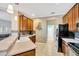 Bright kitchen featuring tile floors, a breakfast bar, black appliances, and seamless flow to living areas at 2321 Wood Pointe Dr, Holiday, FL 34691