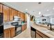 Well-lit kitchen featuring ample cabinet space, mosaic tile backsplash, stainless steel appliances, and seamless flow to living areas at 2321 Wood Pointe Dr, Holiday, FL 34691