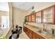 Convenient kitchenette featuring granite countertops, cabinets, and a sink at 2321 Wood Pointe Dr, Holiday, FL 34691