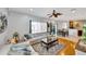 Open-concept living room featuring hardwood floors, neutral furniture, and an adjacent dining area for seamless entertaining at 2321 Wood Pointe Dr, Holiday, FL 34691