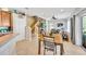 Bright, open-concept living area with wood-look floors, an accent wall, and access to the kitchen and backyard at 2321 Wood Pointe Dr, Holiday, FL 34691