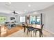 Inviting open-concept living space with wood flooring, a ceiling fan, neutral furniture, and lots of natural light at 2321 Wood Pointe Dr, Holiday, FL 34691