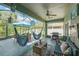 Relaxing screened patio with dining and seating areas, featuring comfortable seating and dining options at 2321 Wood Pointe Dr, Holiday, FL 34691