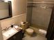 Bathroom with neutral tile accents, dark vanity, and combination tub/shower at 2450 Canadian Way # 6, Clearwater, FL 33763