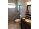 Updated bathroom with tiled shower, vanity, sink, granite countertop, and ample lighting at 2450 Canadian Way # 6, Clearwater, FL 33763
