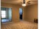 Cozy bedroom with ceiling fan, carpet, and sliding glass doors to the patio at 2450 Canadian Way # 6, Clearwater, FL 33763