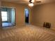 Bedroom with ceiling fan, carpet, and sliding glass doors to the patio at 2450 Canadian Way # 6, Clearwater, FL 33763
