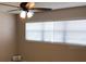 Calm bedroom featuring soft lighting, a ceiling fan, and a serene window view at 2450 Canadian Way # 6, Clearwater, FL 33763