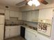 Functional kitchen design featuring white cabinetry and standard appliances at 2450 Canadian Way # 6, Clearwater, FL 33763