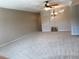 Spacious living area with neutral carpet, ceiling fan, and serene wall color at 2450 Canadian Way # 6, Clearwater, FL 33763