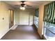 Enclosed patio with sliding glass doors, a ceiling fan, and storage at 2450 Canadian Way # 6, Clearwater, FL 33763