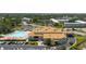 Aerial view of community amenities, including the clubhouse and a sparkling outdoor pool at 2457 Ecuadorian Way # 63, Clearwater, FL 33763