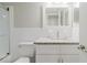 White bathroom features granite vanity, tiled shower-tub with glass doors, and chrome fixtures at 2457 Ecuadorian Way # 63, Clearwater, FL 33763