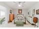 Bedroom featuring light gray walls, wood-look floors, and a ceiling fan for added comfort at 2457 Ecuadorian Way # 63, Clearwater, FL 33763
