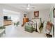 Bright bedroom features a ceiling fan, light gray walls, and whitewashed wood-look floors at 2457 Ecuadorian Way # 63, Clearwater, FL 33763