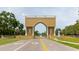 Community entrance features a grand archway leading to lush landscaping at 2457 Ecuadorian Way # 63, Clearwater, FL 33763