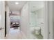 Hallway view into an adjacent living room and bathroom with a sliding glass door at 2457 Ecuadorian Way # 63, Clearwater, FL 33763