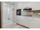 Bright kitchen with granite counters, stainless appliances, tile backsplash, and plenty of cabinet space at 2457 Ecuadorian Way # 63, Clearwater, FL 33763