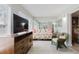Comfortable living room featuring floral sofa, wicker chair and large TV at 2457 Ecuadorian Way # 63, Clearwater, FL 33763