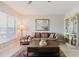 Bright living room with natural light, wood floors, a patterned couch, and stylish decor at 2457 Ecuadorian Way # 63, Clearwater, FL 33763
