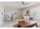 Bright living room featuring light wood floors, ceiling fan, a window, and dining area at 2457 Ecuadorian Way # 63, Clearwater, FL 33763