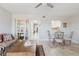 Open living room with ceiling fan, light wood floors, and views of the kitchen at 2457 Ecuadorian Way # 63, Clearwater, FL 33763