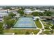 Aerial view of the community tennis courts, nestled amongst the lush landscaping at 2457 Ecuadorian Way # 63, Clearwater, FL 33763