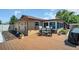 Spacious backyard deck with outdoor seating, lush landscaping, and access to a sunroom, perfect for relaxation at 2597 Bramblewood E Dr, Clearwater, FL 33763