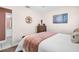 Comfortable bedroom with a queen bed, wooden dresser, and a decorative tree art piece at 2597 Bramblewood E Dr, Clearwater, FL 33763