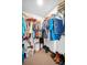 Walk-in closet offering ample storage with racks, shelves, and organized clothing, shoes, and accessories at 2597 Bramblewood E Dr, Clearwater, FL 33763