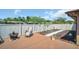 Inviting backyard deck with a chair, planting beds and a cozy fire pit, ideal for relaxation and outdoor enjoyment at 2597 Bramblewood E Dr, Clearwater, FL 33763