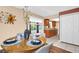Cozy dining room features stylish decor, a warm, inviting atmosphere, and a direct view into the beautifully updated kitchen at 2597 Bramblewood E Dr, Clearwater, FL 33763