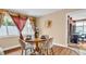 Cozy dining area featuring a round table with seating for four, and tasteful window decor at 2597 Bramblewood E Dr, Clearwater, FL 33763