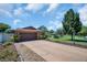 Well-maintained home featuring a two-car garage, manicured lawn, and vibrant landscaping, offering curb appeal at 2597 Bramblewood E Dr, Clearwater, FL 33763