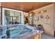 Relaxing outdoor hot tub on a covered patio, with easy access to the house, perfect for entertaining or unwinding at 2597 Bramblewood E Dr, Clearwater, FL 33763