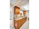 Well-maintained kitchen featuring modern countertops, stainless appliances, and a pass-through window into another room at 2597 Bramblewood E Dr, Clearwater, FL 33763