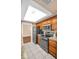 Bright kitchen with stainless steel appliances, stylish countertops, a skylight, and ample cabinetry at 2597 Bramblewood E Dr, Clearwater, FL 33763